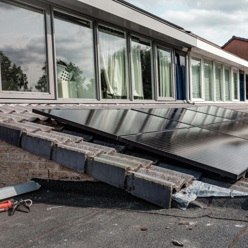Rooftop solar panels on a modern house, optimizing energy efficiency.